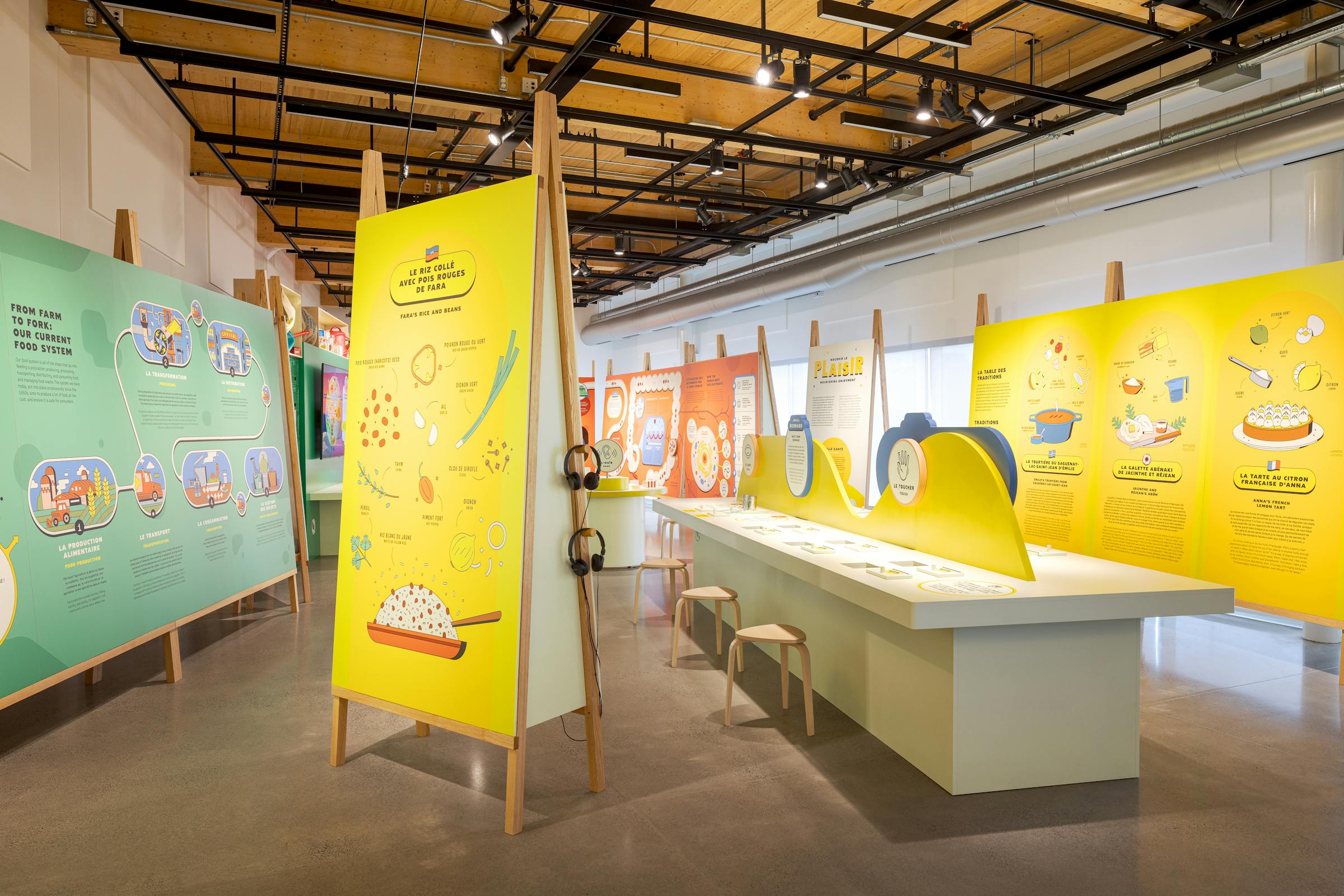 Exhibition space with colorful explanatory panels and interactive installations on the food system.