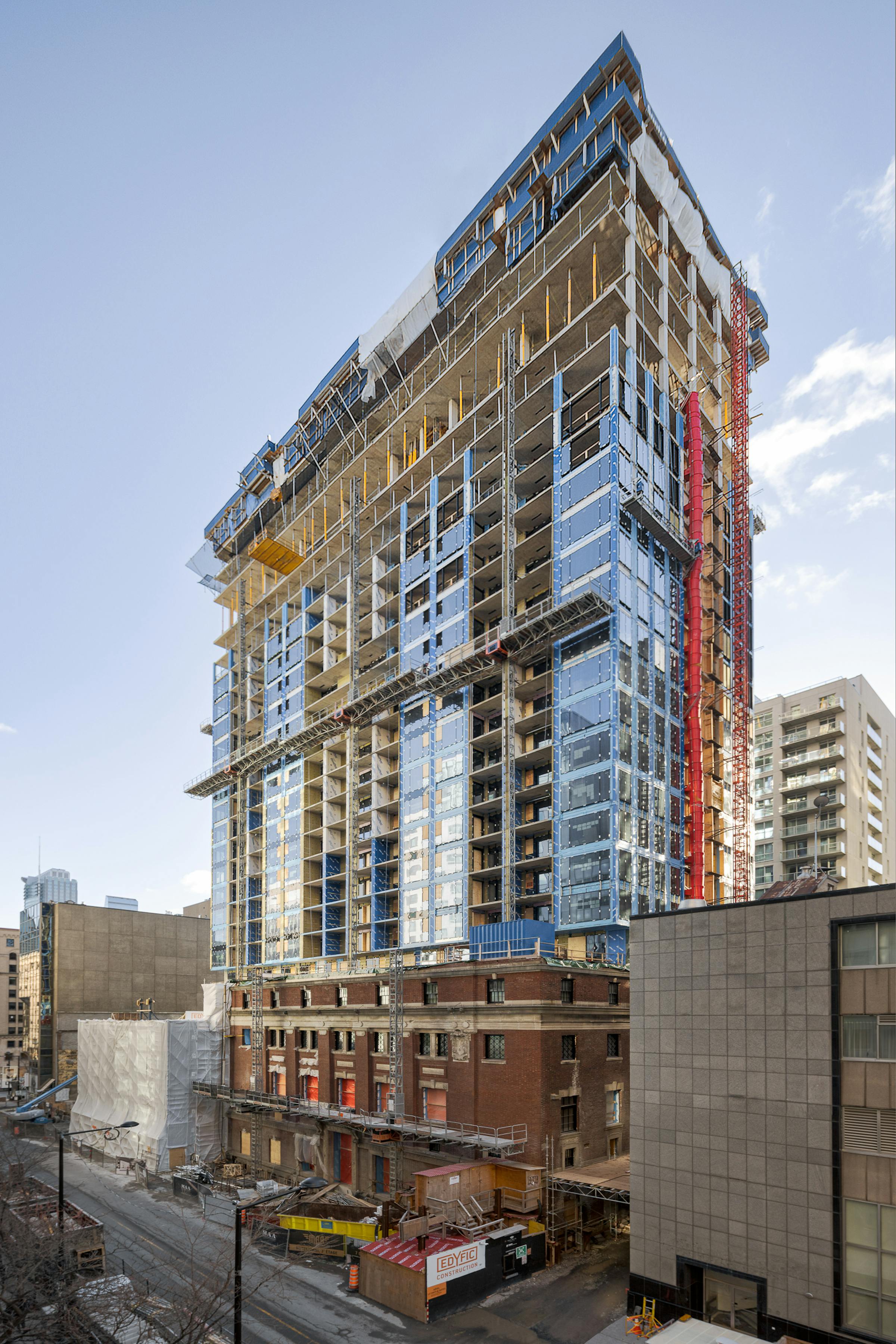 Wide angle photograph of a condor tower under construction.
