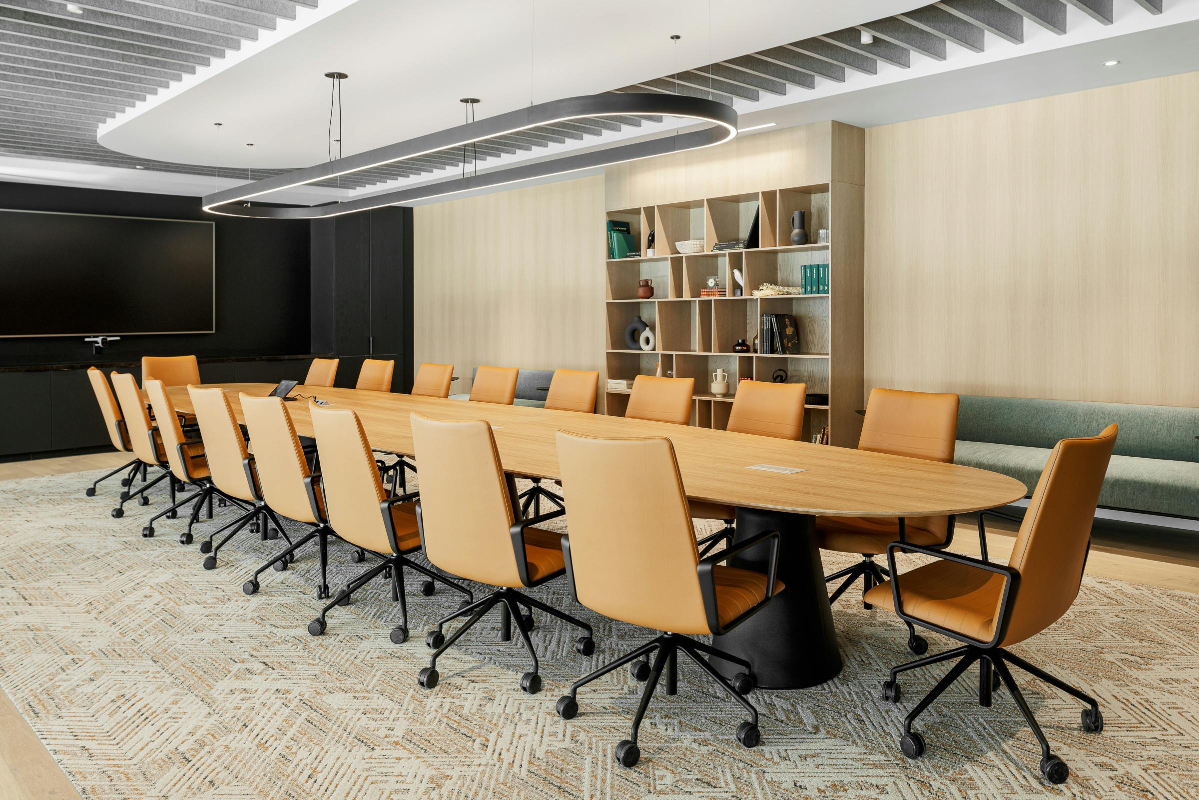 Meeting room with inspired architecture, long wooden table and leather armchairs.