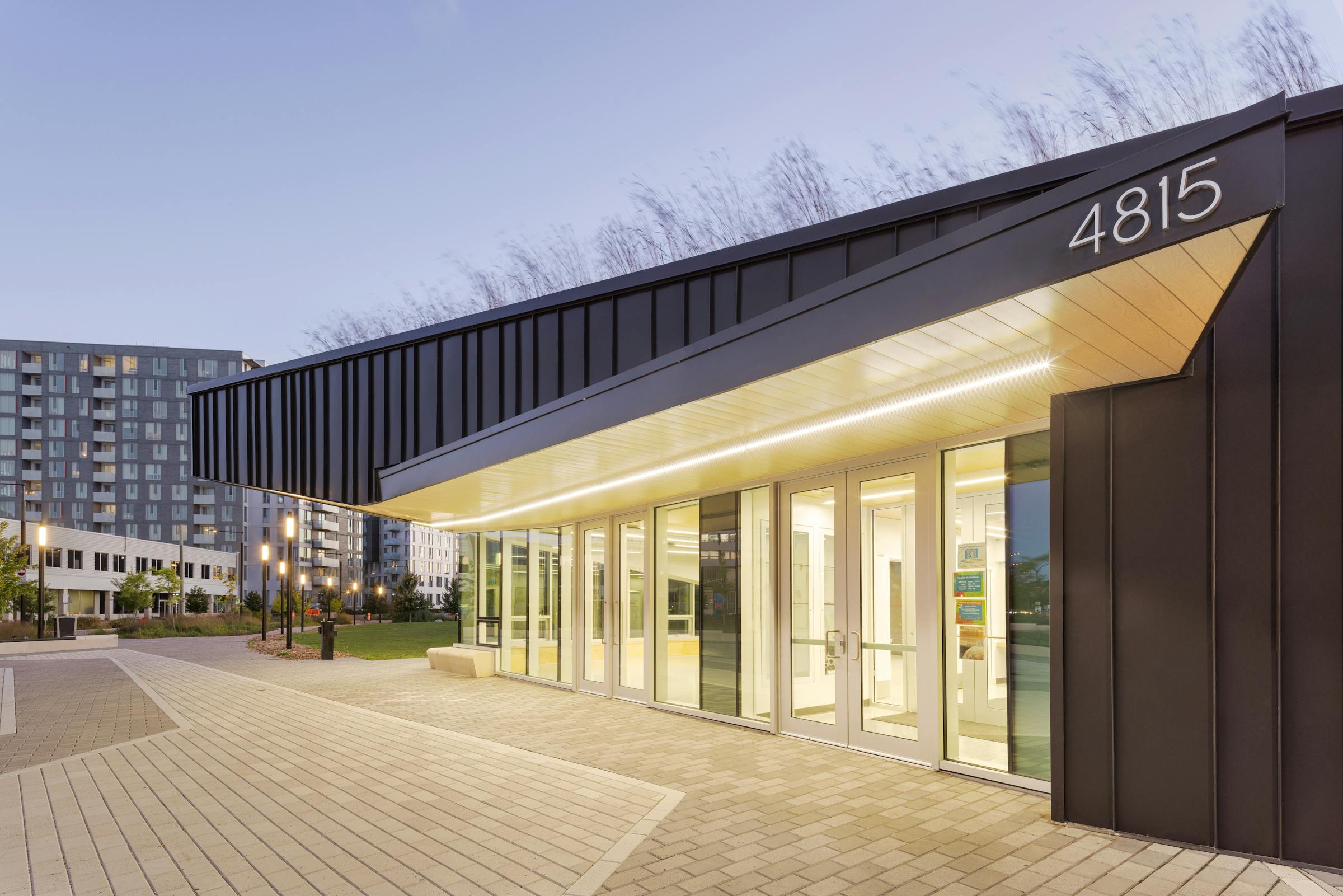 Architectural photography at sunset of the facade of a community building with a dominant of artificial lighting.