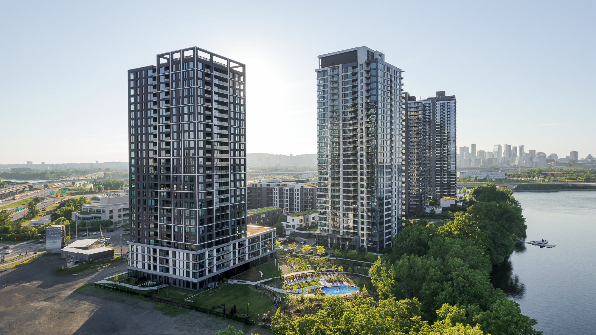 Exterior view of the residential Evolo NEX tower integrated into Montreal’s riverside landscape.