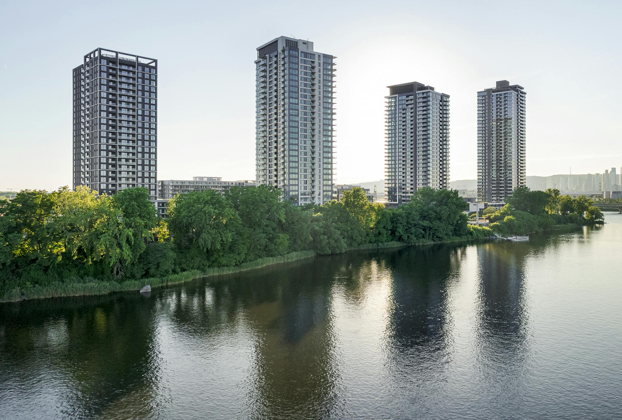 Silhouette élancée d’Evolo NEX se reflétant sur le fleuve Saint-Laurent.