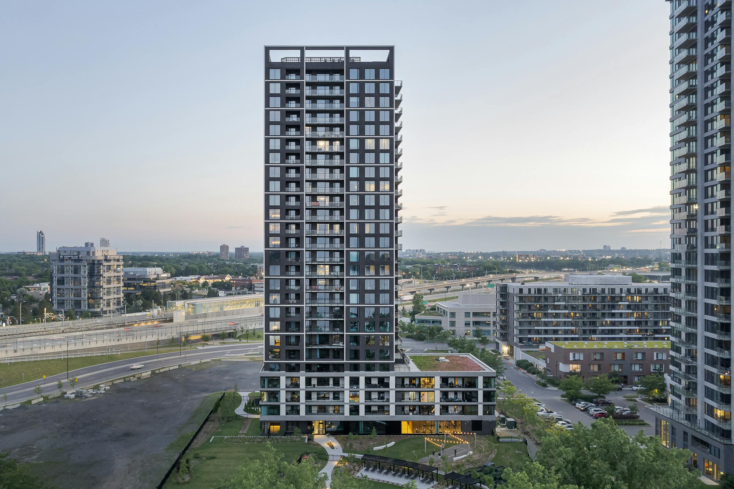 Contemporary façade of the Evolo NEX tower in Montreal with a view of the Saint Lawrence River.