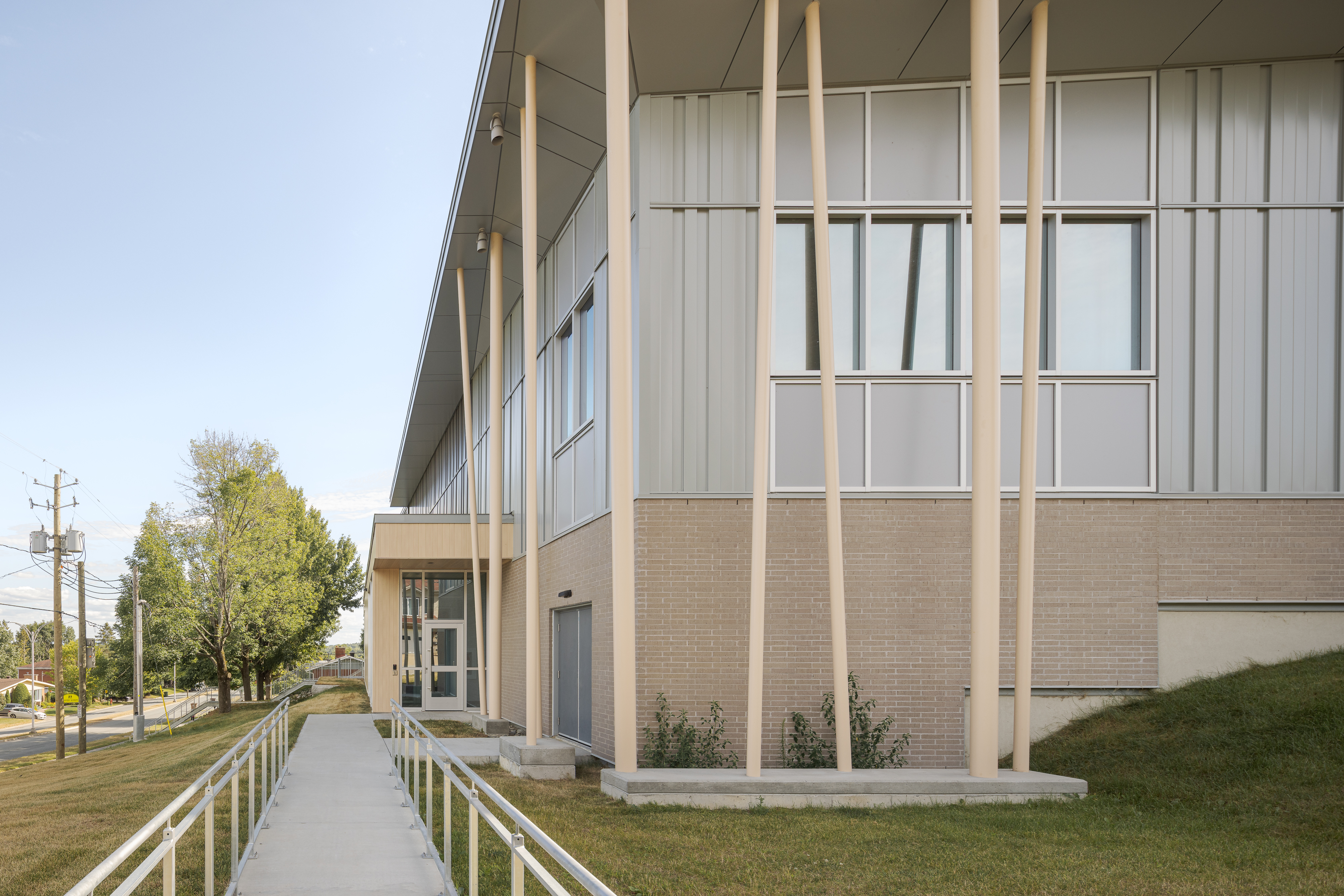 Perspective sur les volumes du bâtiment, en interaction avec le terrain en pente.
