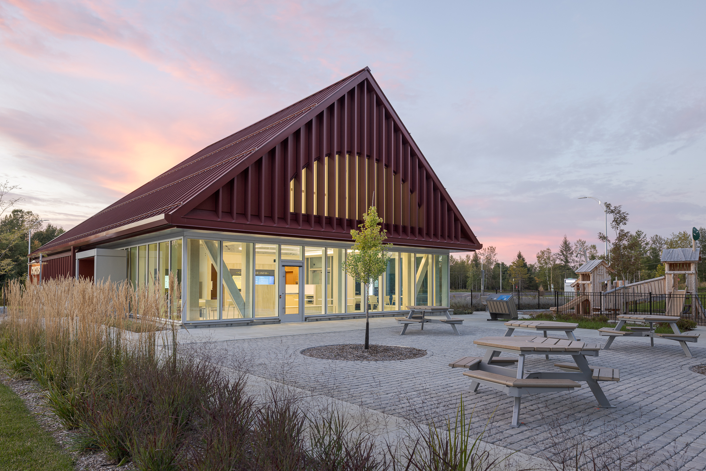 Red facade of the rest area contrasting with the surrounding natural landscape.