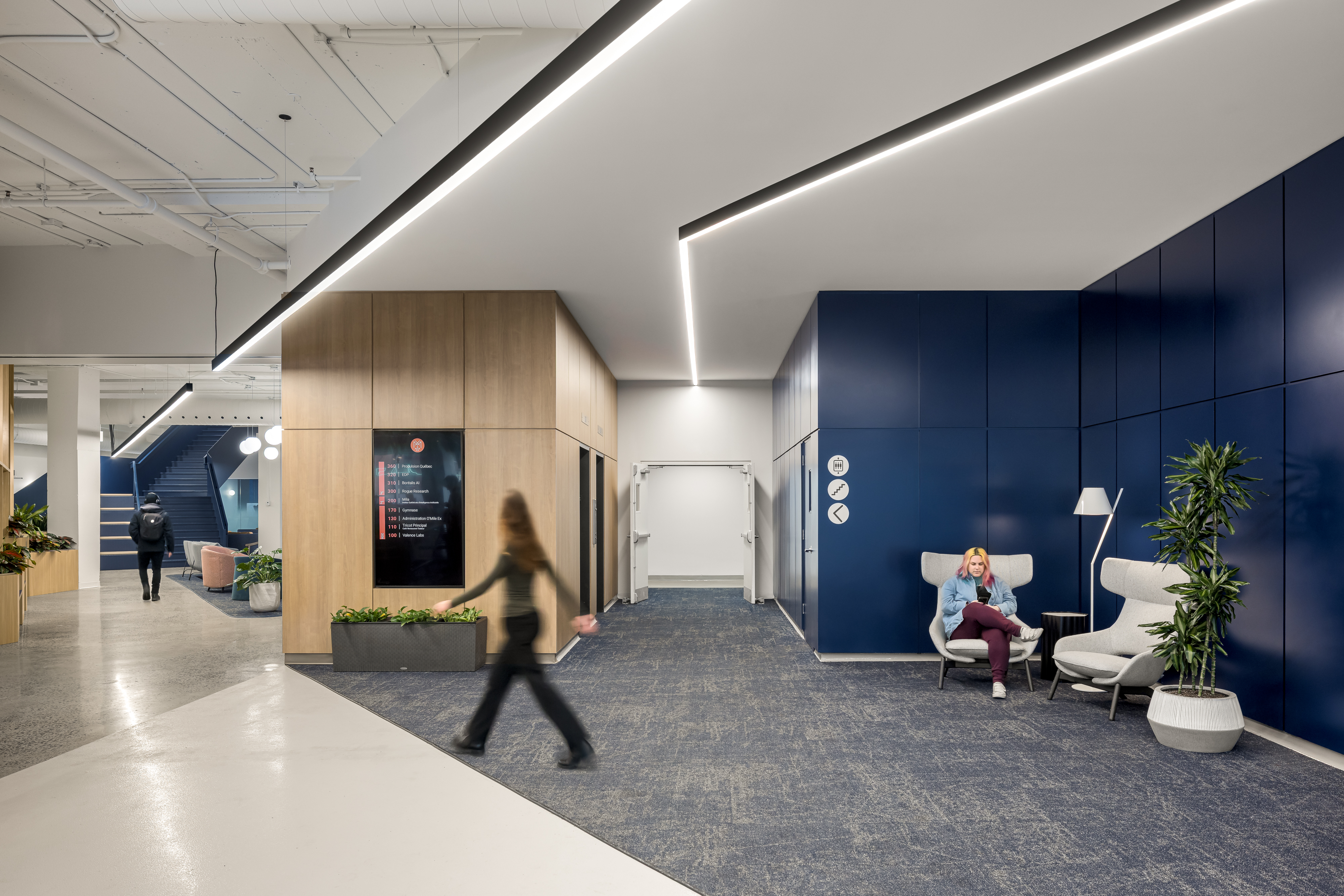 Photographie d’architecture d’une zone de détente avec fauteuils modernes et composition architecturale forte.