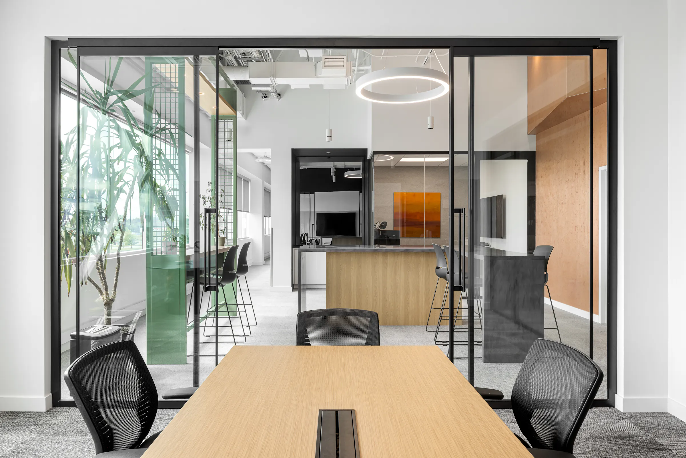 Photographie d’architecture d’un corridor de bureaux modernes avec structure apparente, design intérieur et lumière naturelle.