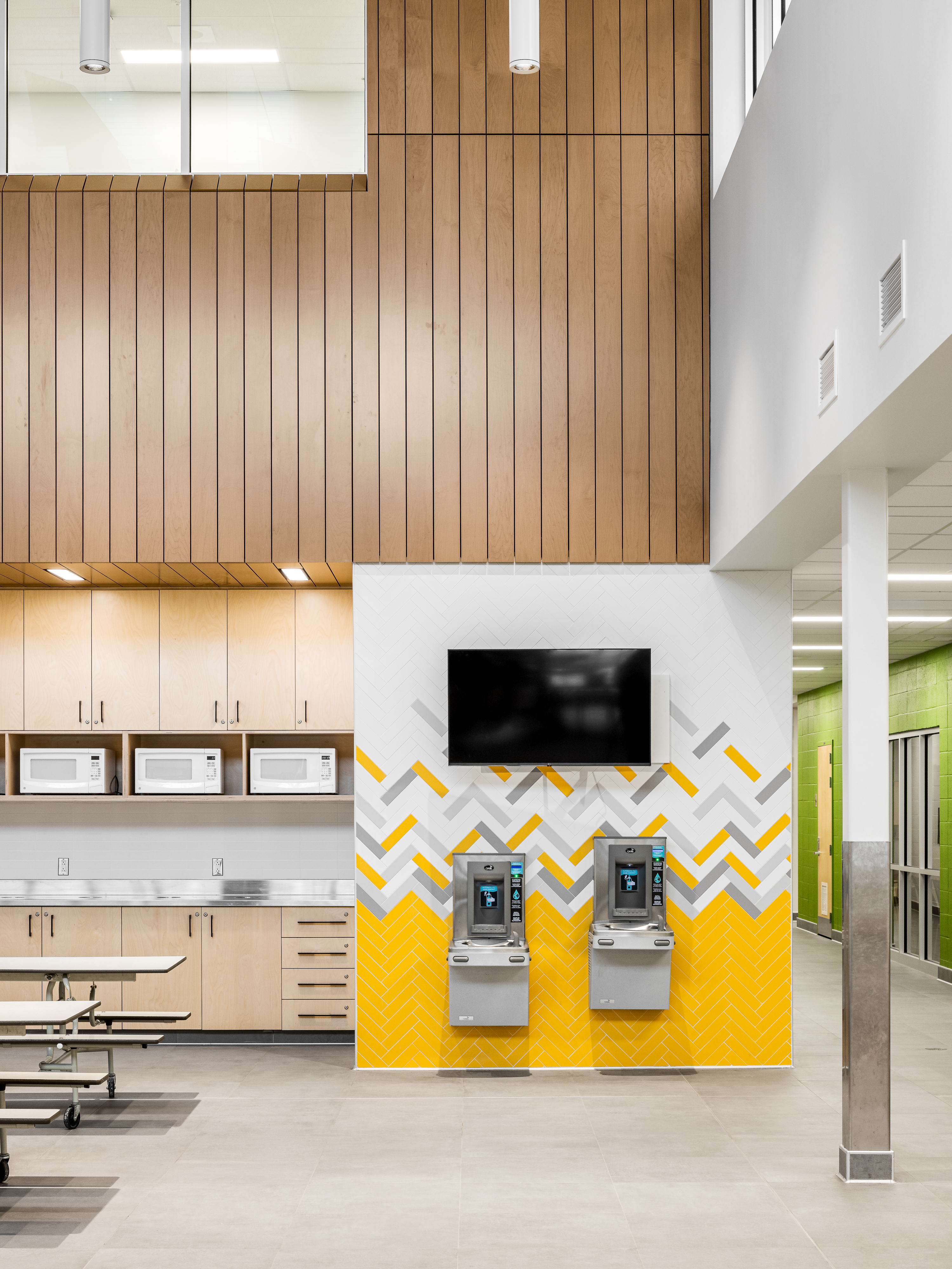 Traffic corridor with yellow graphic signage and directional arrows, playful and colorful design. Photo: TARMAC - Damien Ligiardi