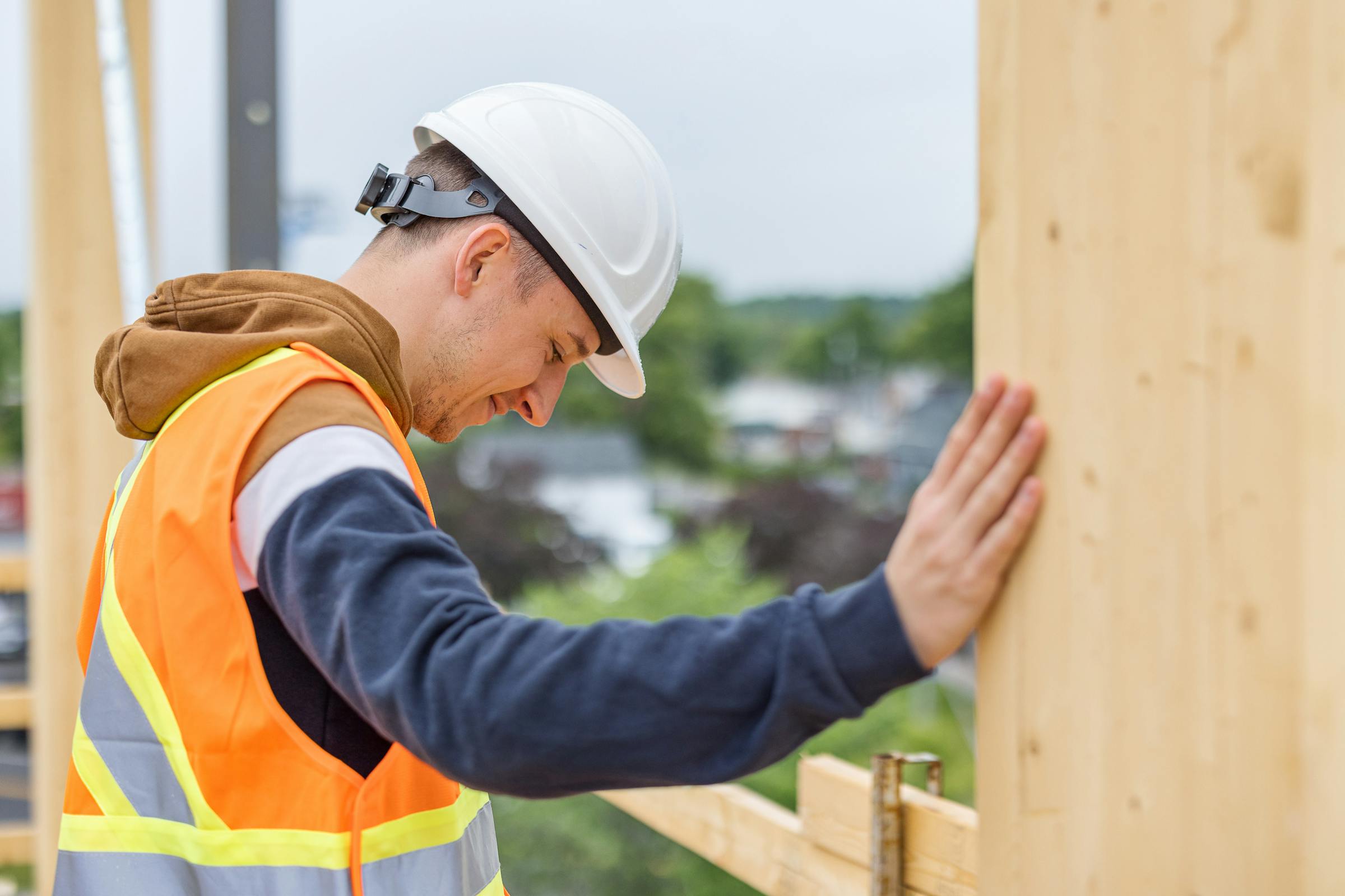 Employee touching and inspecting quality of solid wood structures