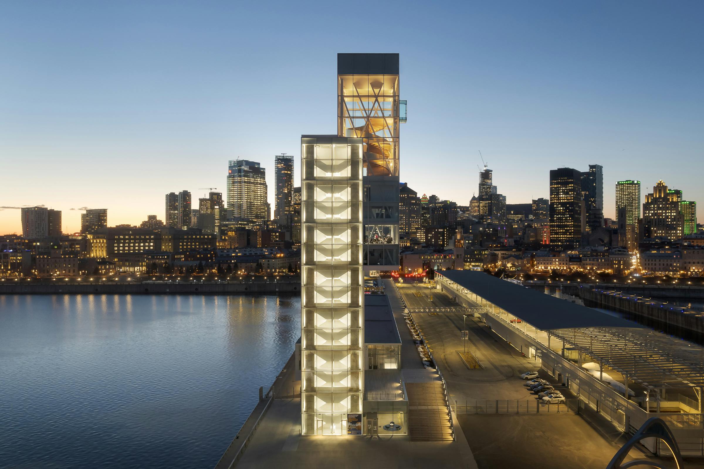 Aerial photographer of the architecture of the Grand-Quai observation tower with the city of Montreal in the background.