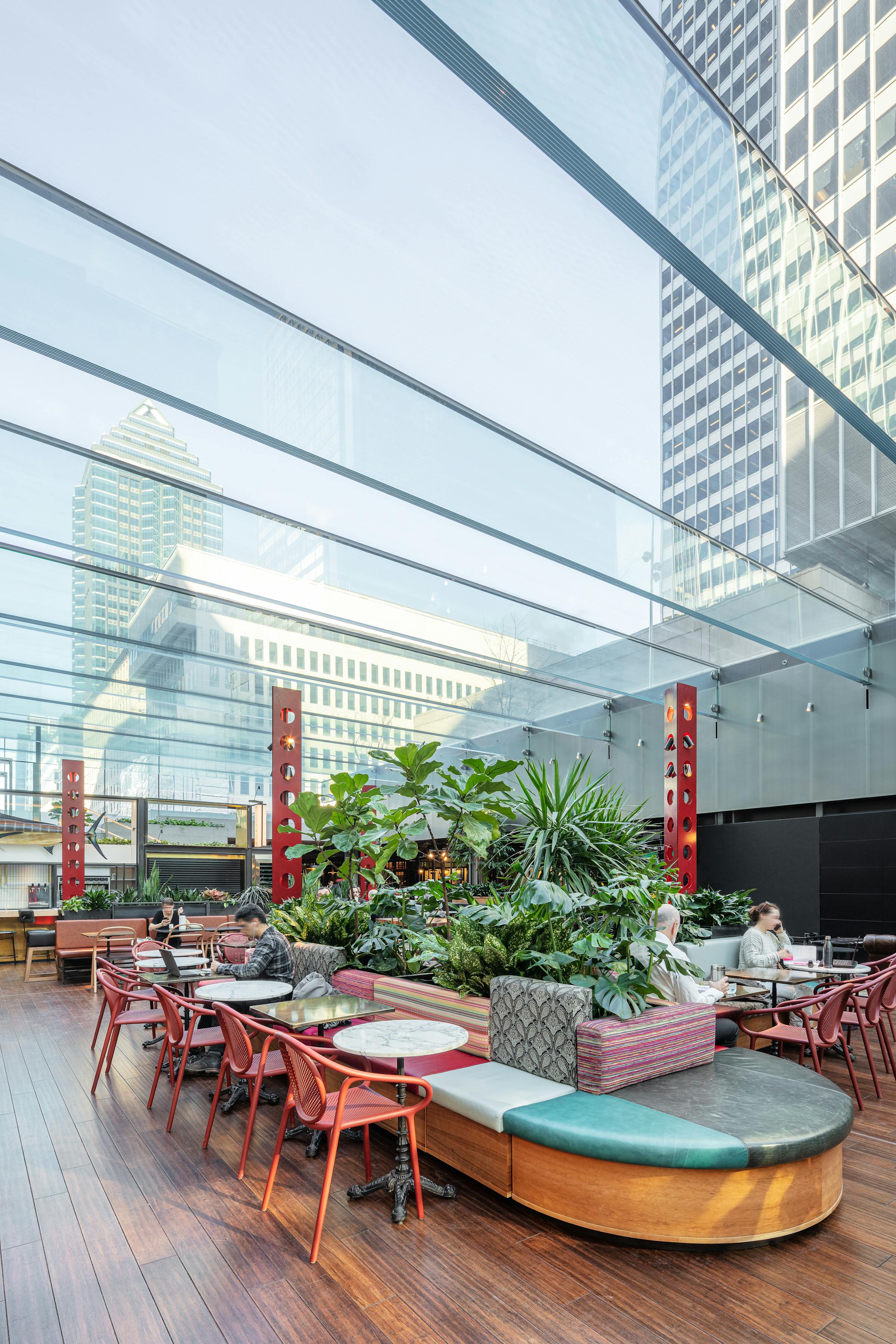 Professional architectural photography of the interiors of a garden under a glass ceiling.