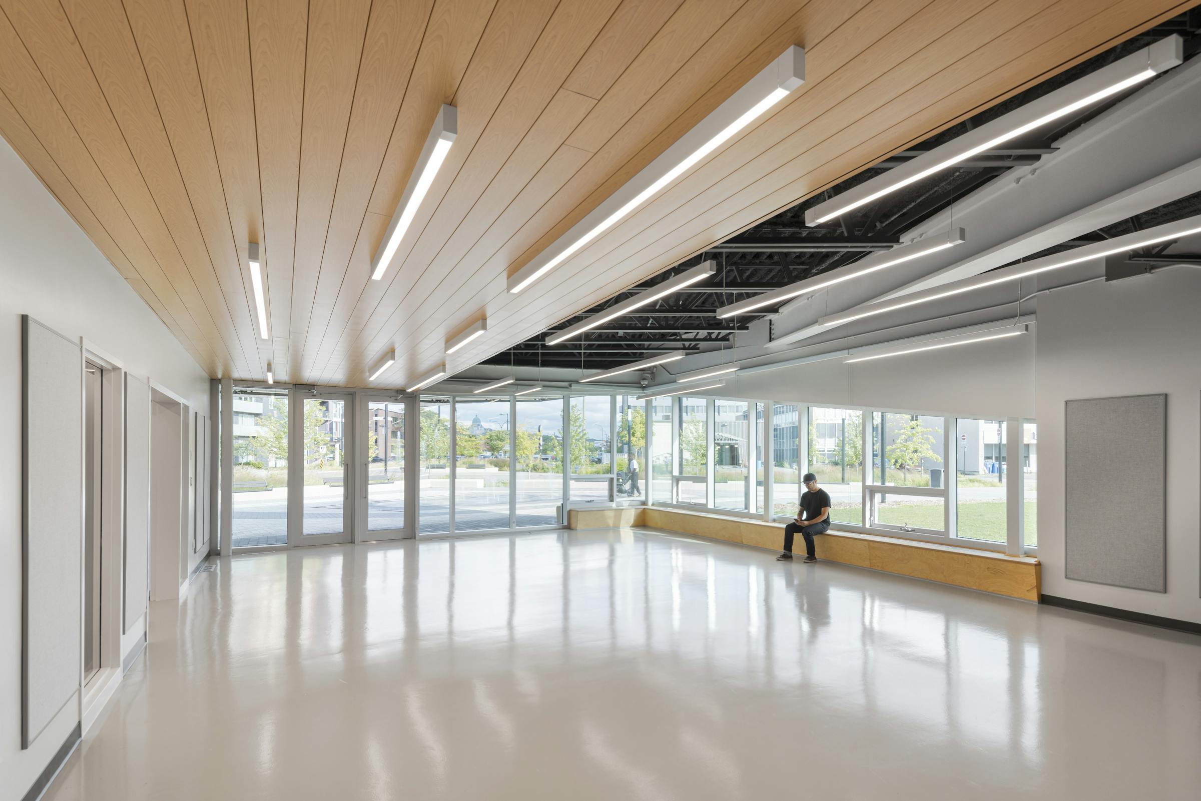 Wide angle photograph of the main room of a community center in Montreal.