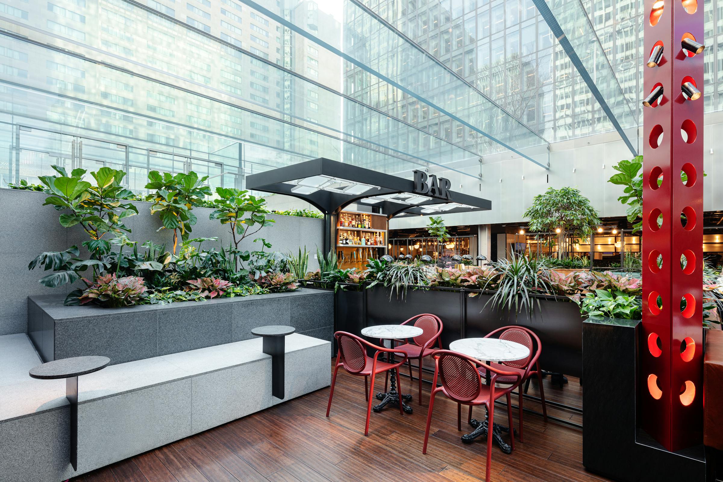 Architectural photograph of a restaurant in a food court in Montreal with designer and colorful furniture.