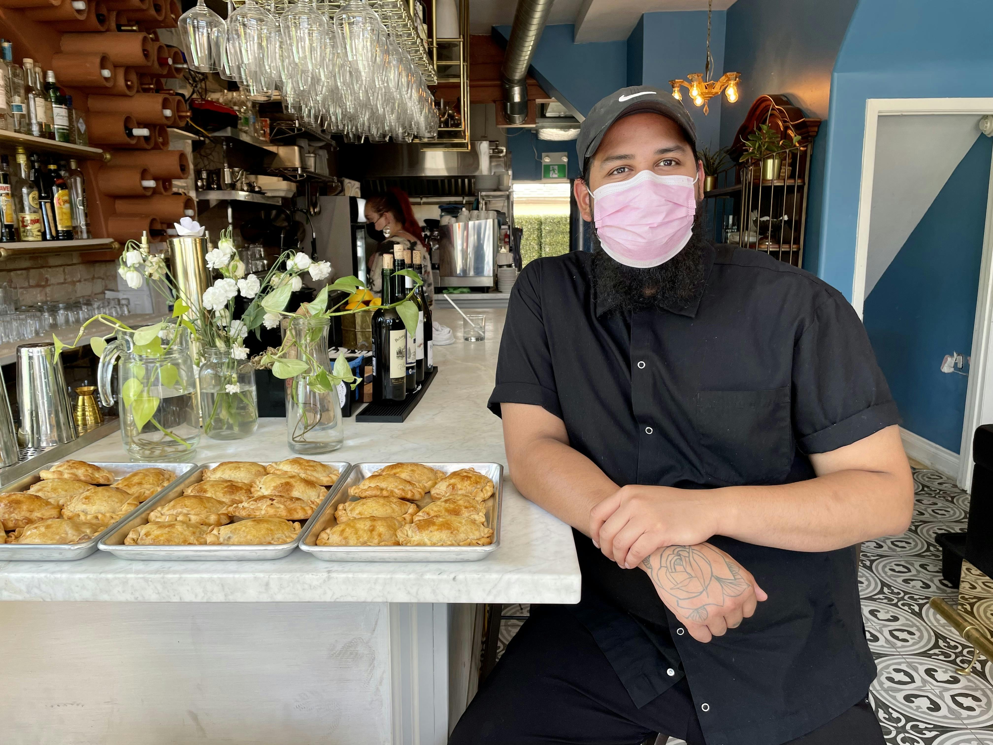 Chef André Burgos and freshly-rolled empanadas
