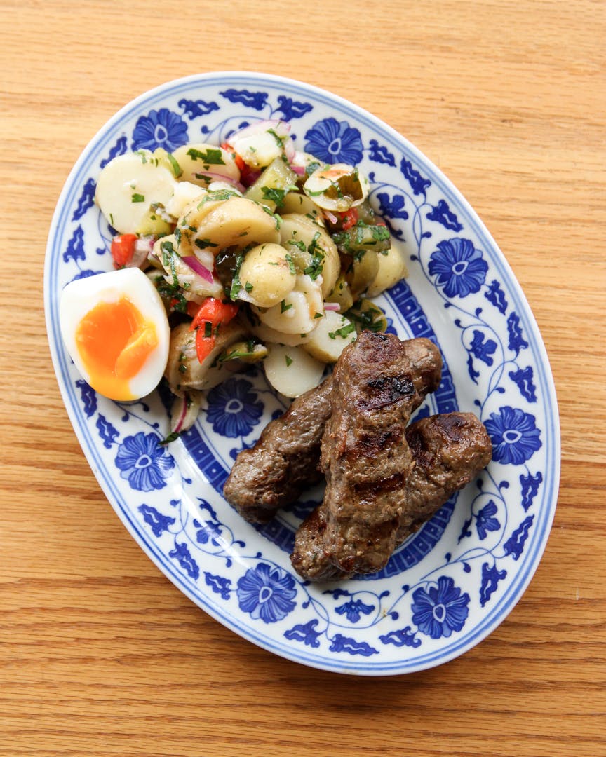 Mititei beef sausages with Romanian potato salad and soft-boiled egg