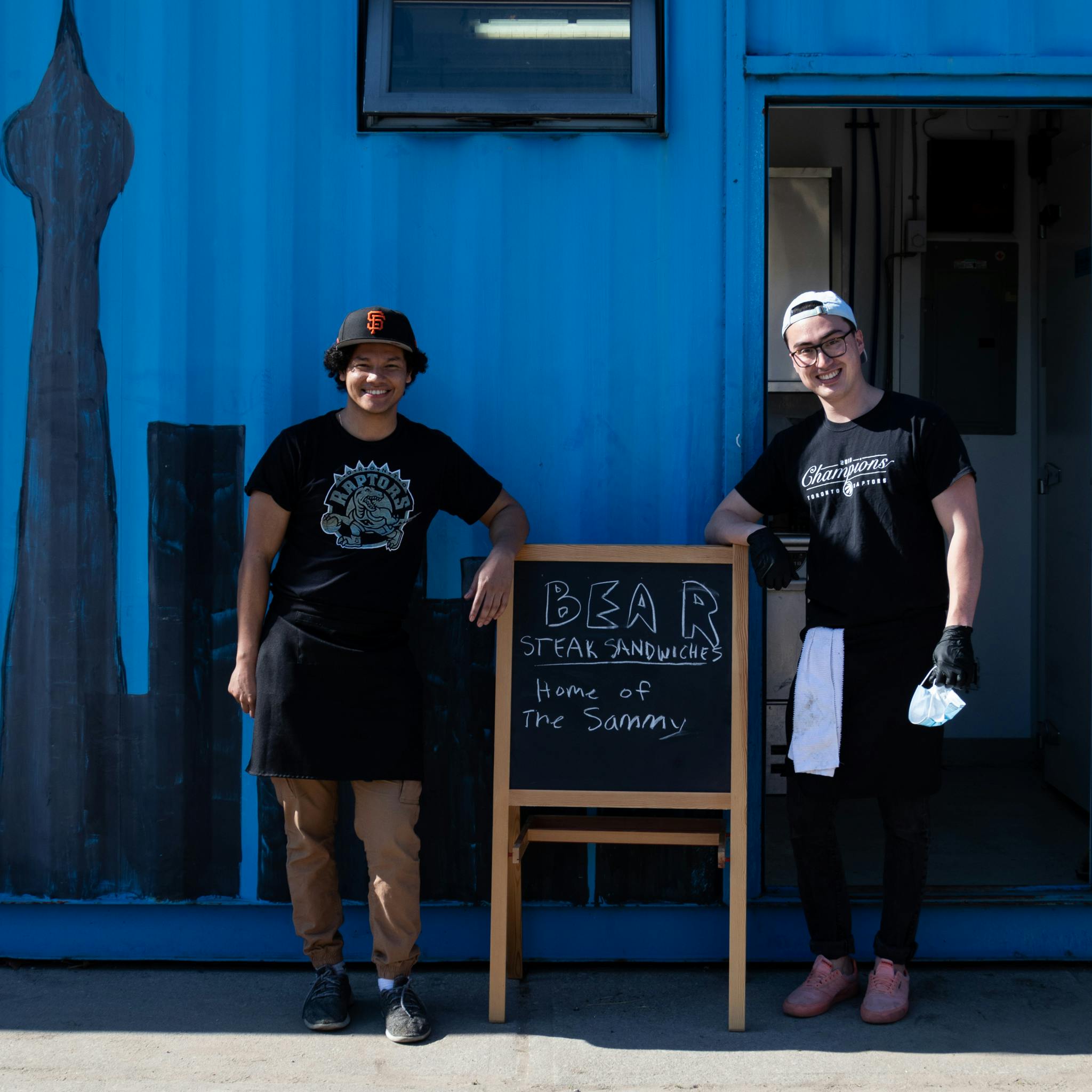 Ricardo Barrientos and Aki Erenberg outside their new temporary location behind Scadding Court Community Centre