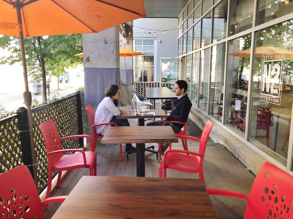 A couple enjoying the last of patio season