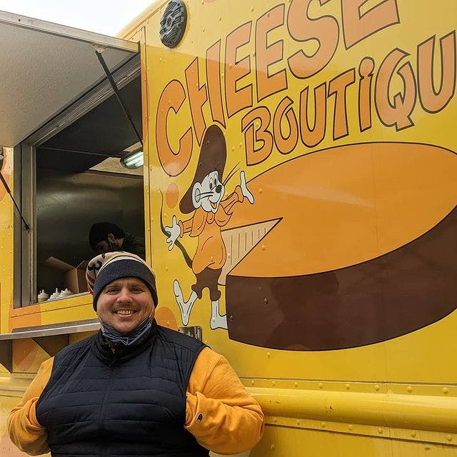Chef Victor Barry poses with the Cheese Boutique food truck