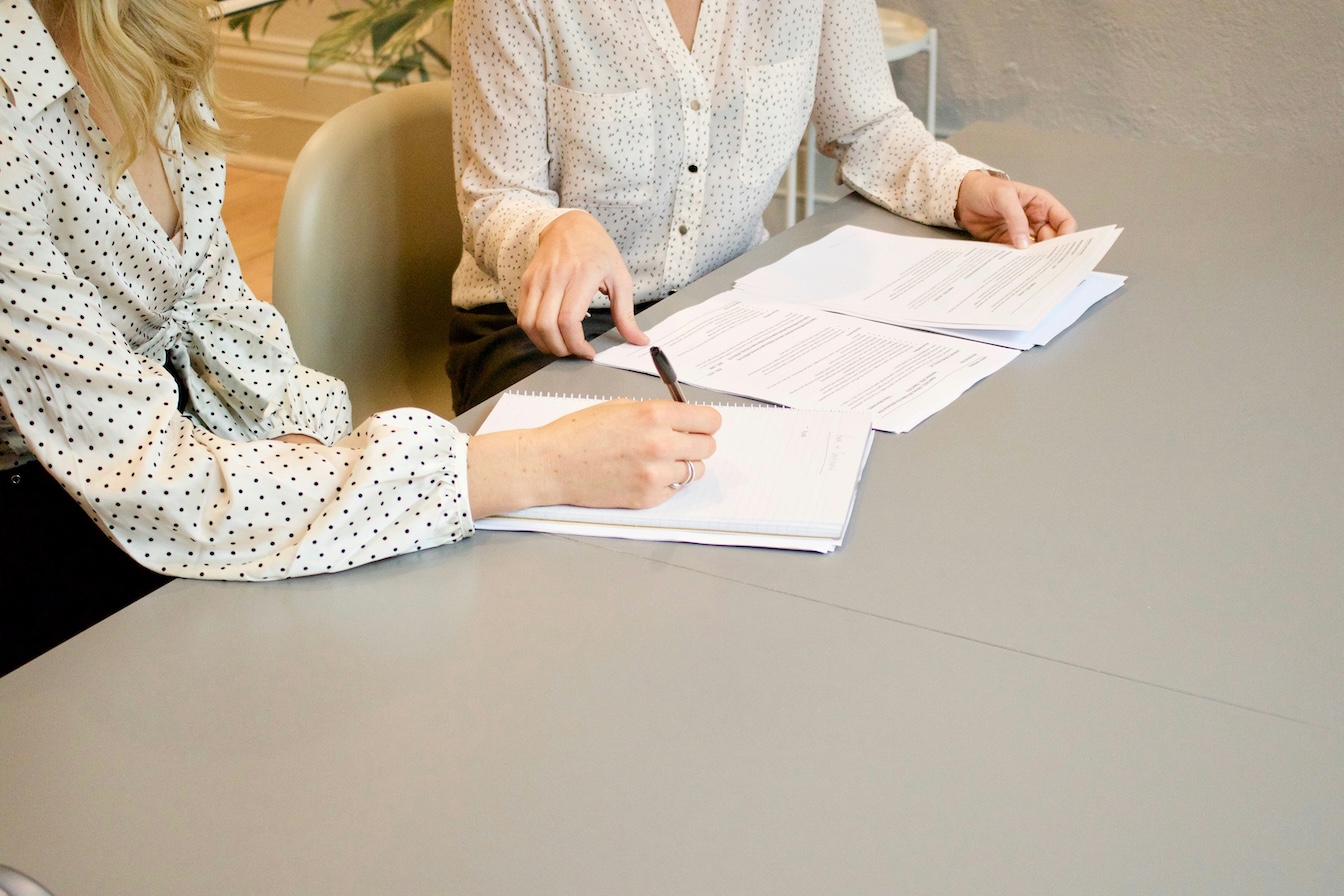 Employer and employee reviewing and signing contract