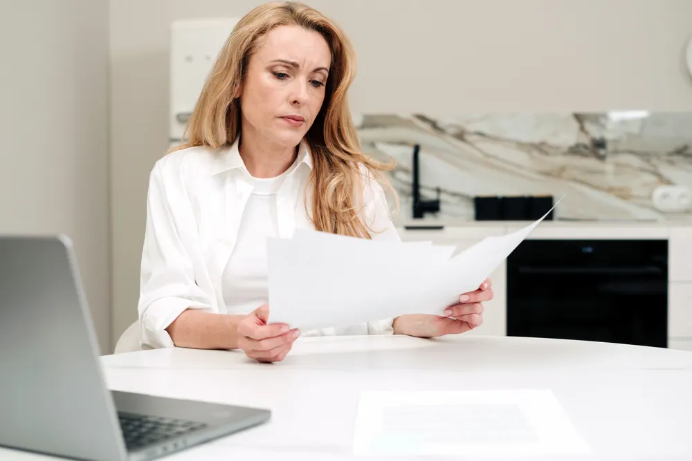 An image showing an accounts auditing the documents of her clients to ensure they are MTD-ready