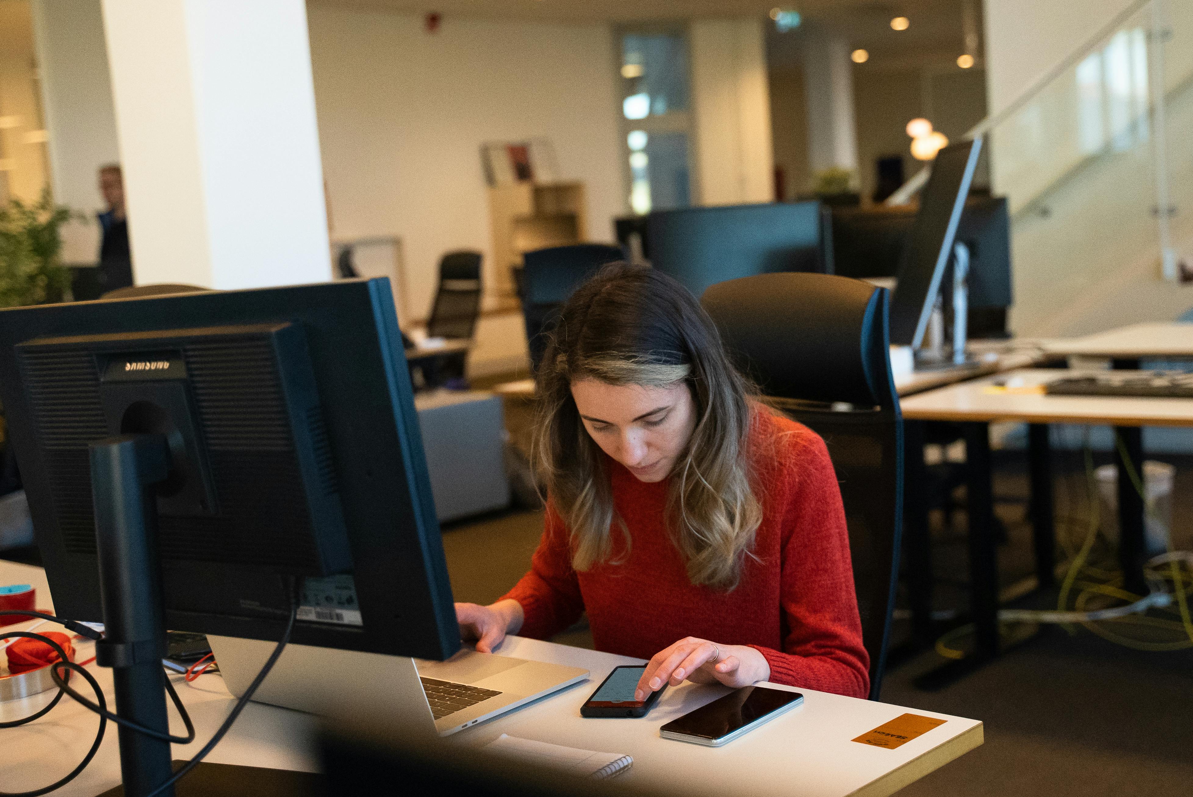 Ana working at her desk in the Truecaller Stockholm office