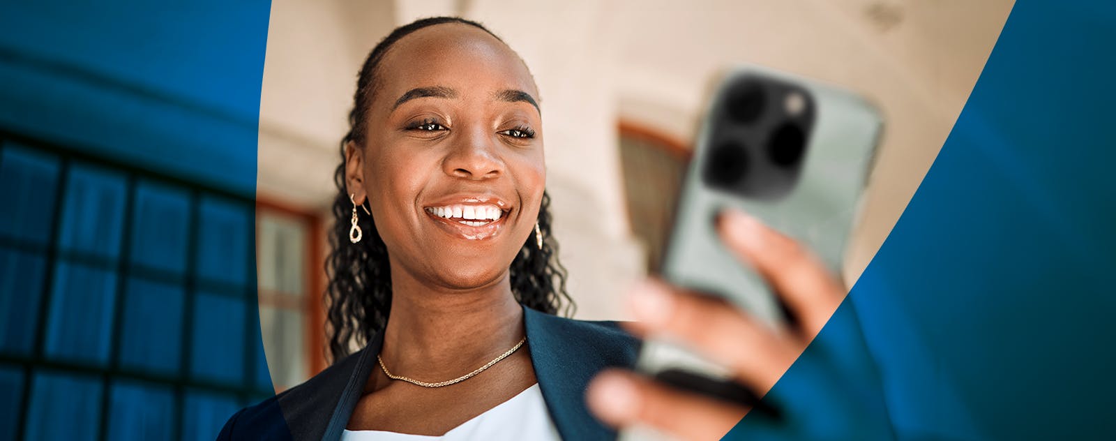 Image of a smiling woman holding a phone