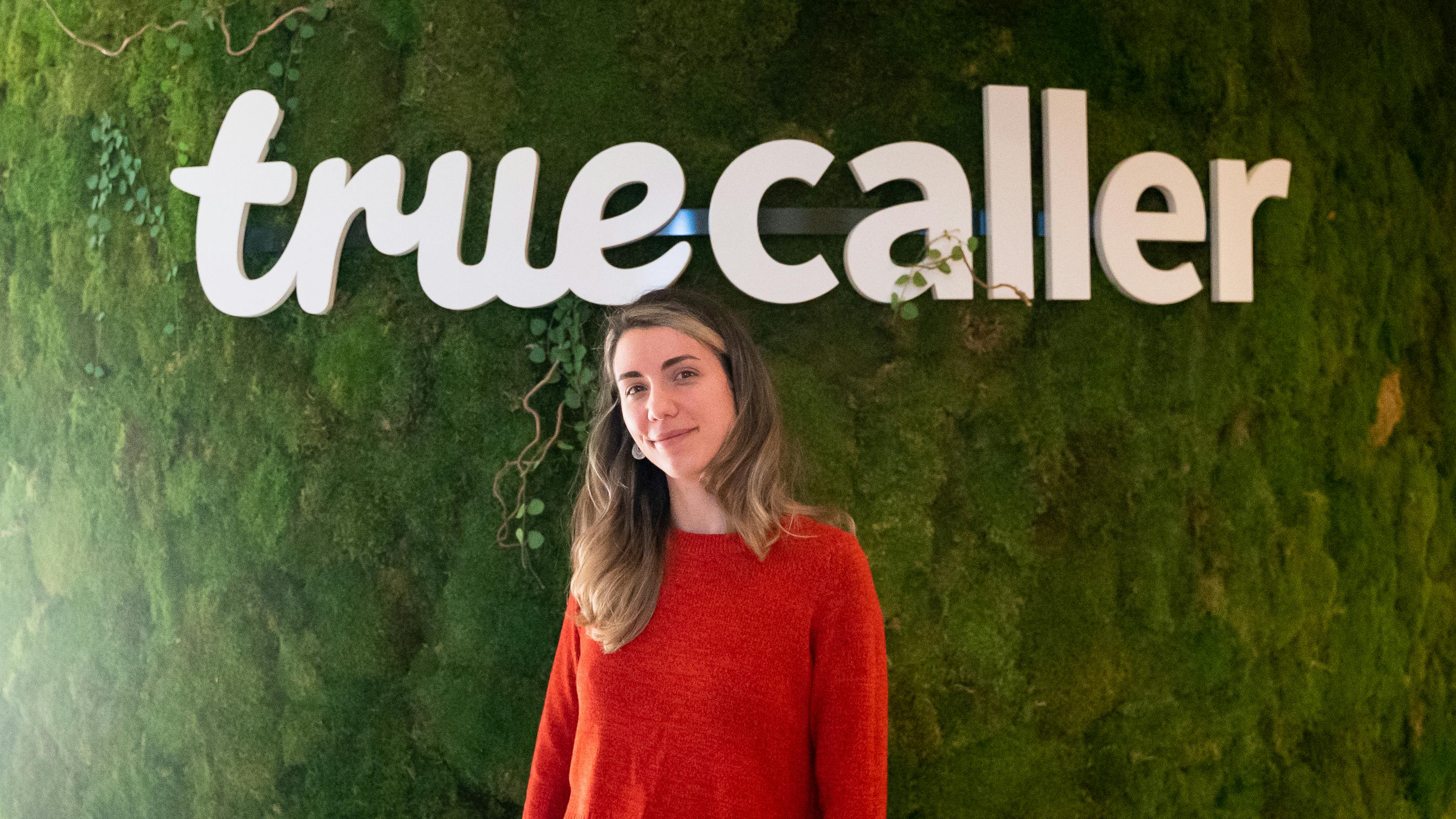 Ana in front of the Truecaller logo in the Truecaller HQ