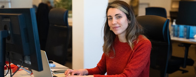 Ana Filote, Test Engineer at Truecaller, working on her computer