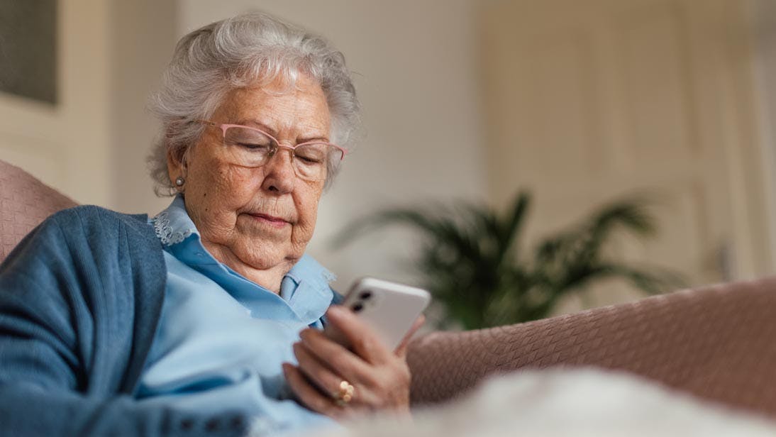 grandmother looks at phone