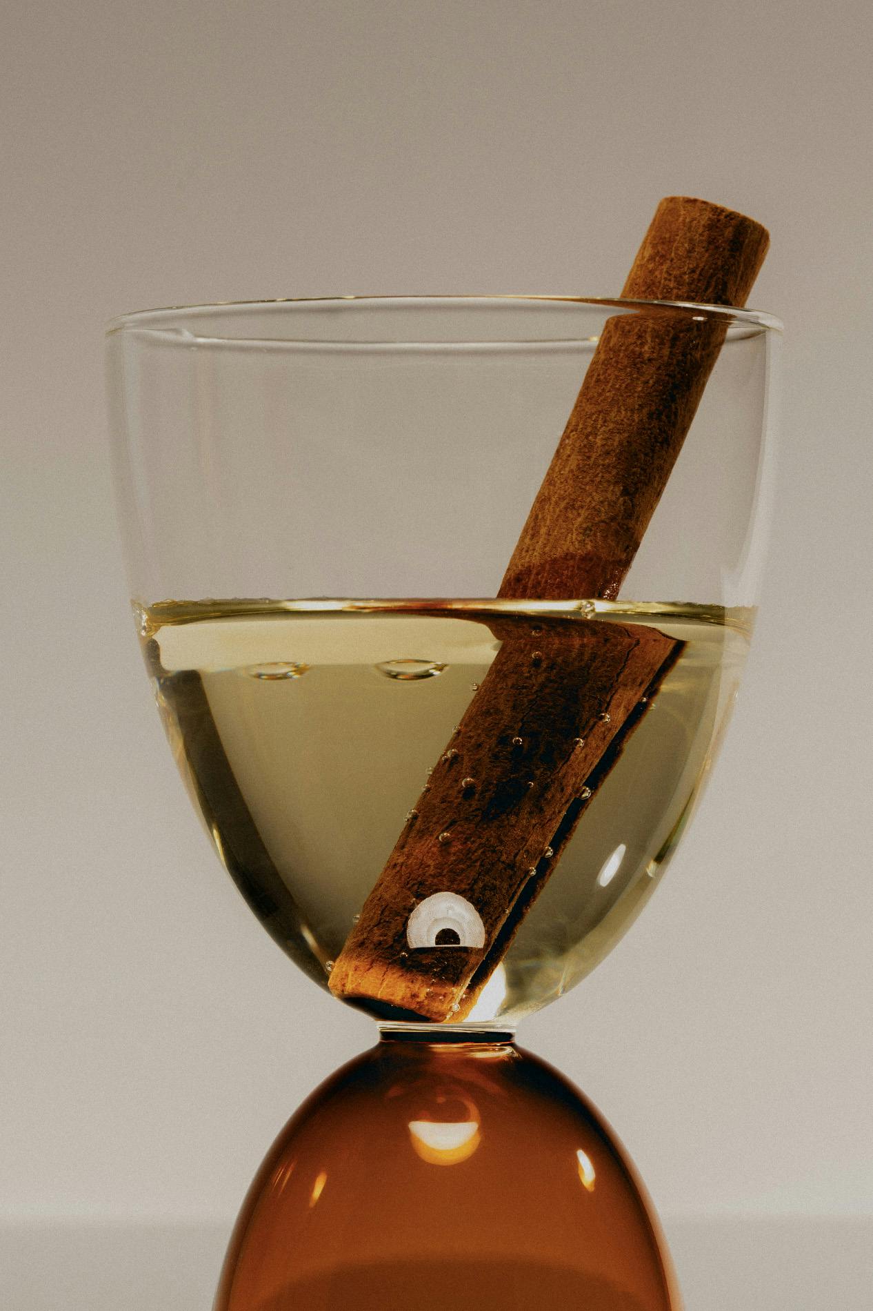 Liquor in shot glass with cinnamon stick inside