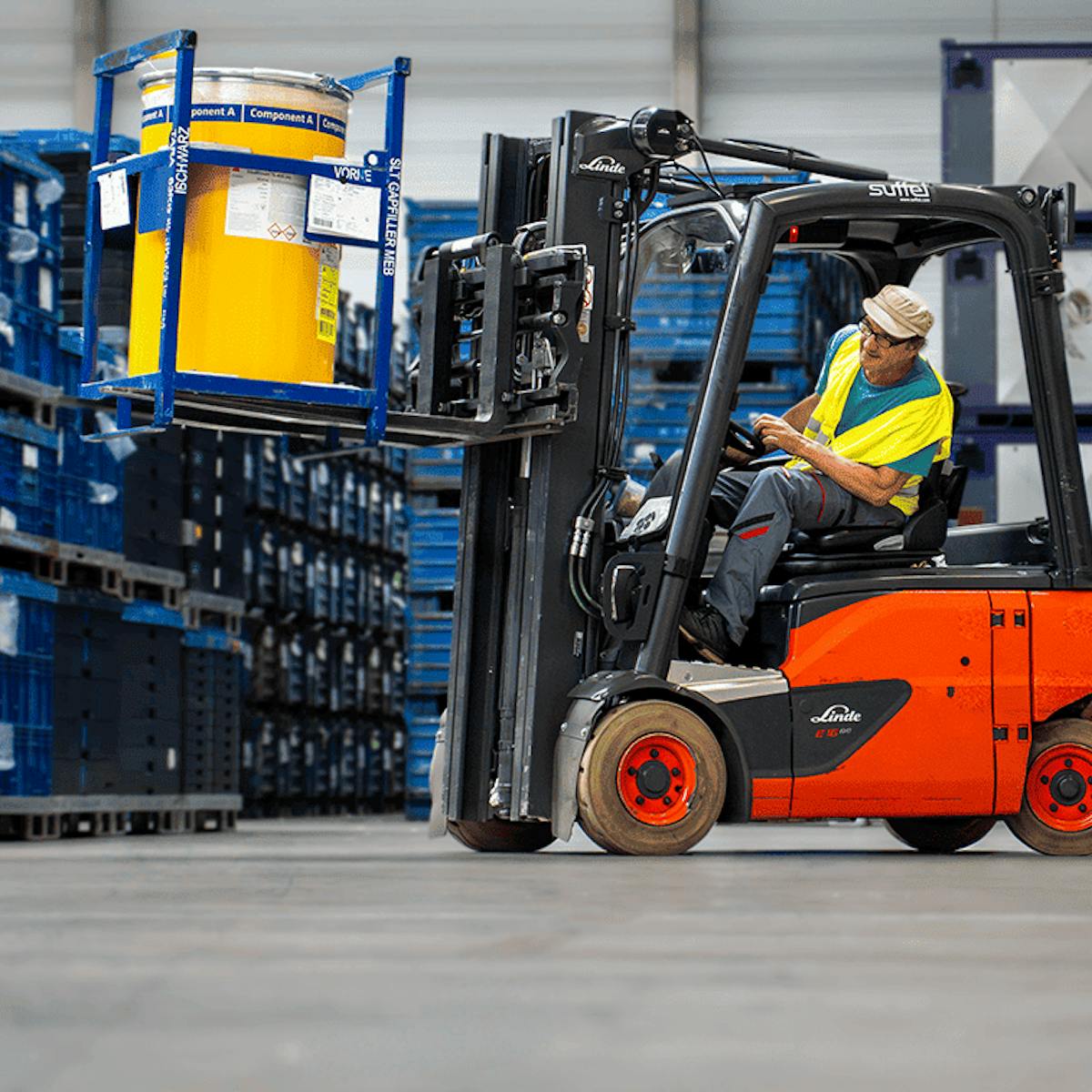 Mann fährt Stapler und transportiert Fässer