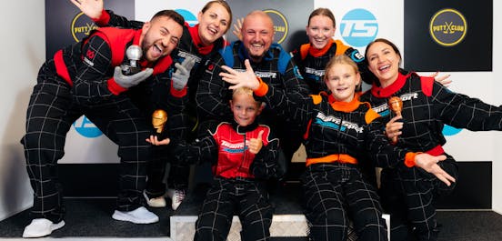 family celebrating their karting wins on the podium