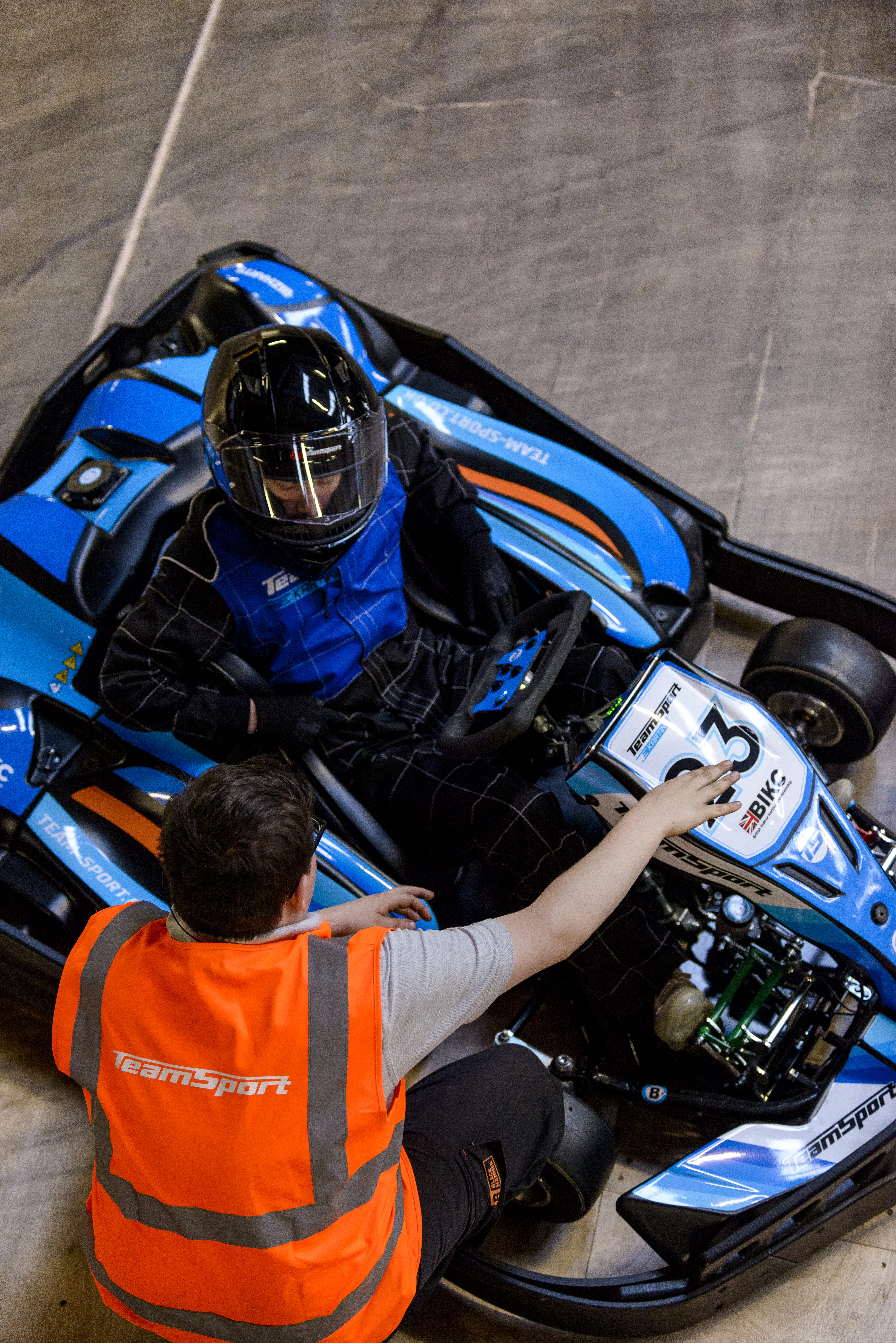 Go-kart driver racing around a corner