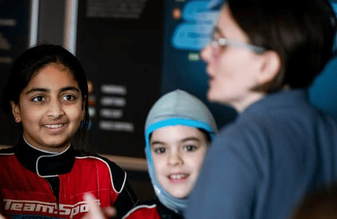 Girls Karting Academy Lesson huddled together