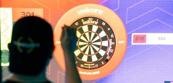 E-Darts player lining up with board