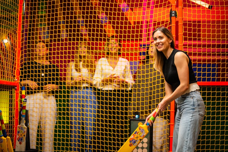 Girl playing virtual cricket at TeamSport Bournemouth