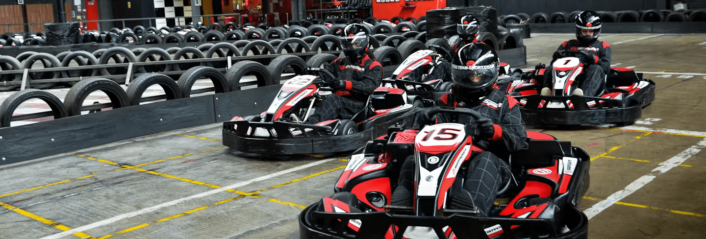 Go-Karting On TeamSport Track In Red Karts