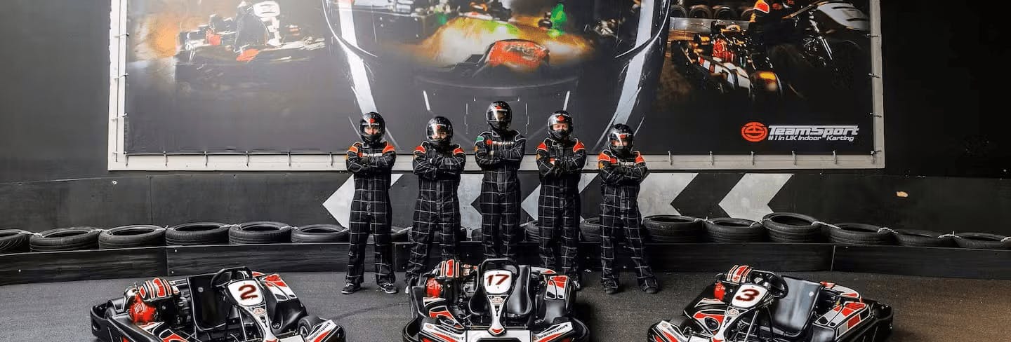 Group Of Karters Posing Infront Of Karts