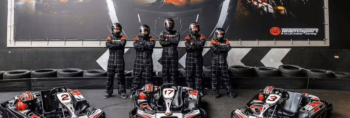 Group Of Karters Posing Infront Of Karts