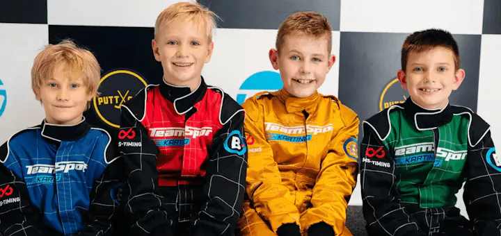 Kids sitting on podium at party