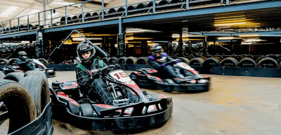 Two karters racing in red petrol karts