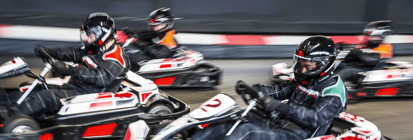 Karters Racing In Red Petrol Karts