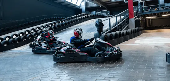 Karters Racing In Red Petrol Karts