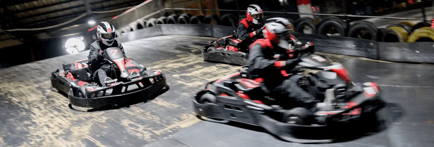 Karters Racing In Red Petrol Karts 