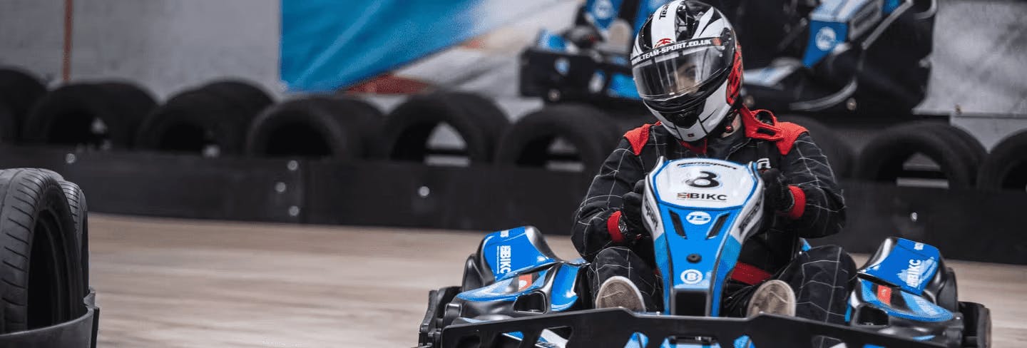 male karter in blue electric kart