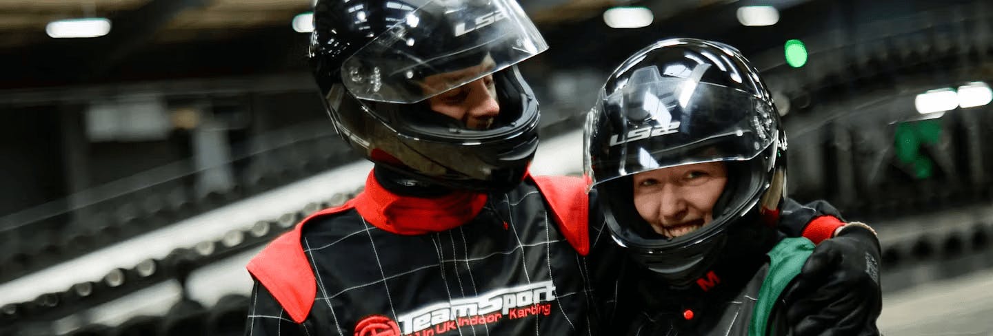couple in karting gear 