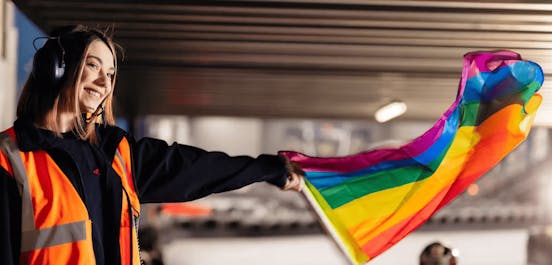 marshal holding a rainbow flag