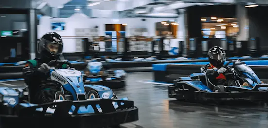 Three karters racing in blue electric karts