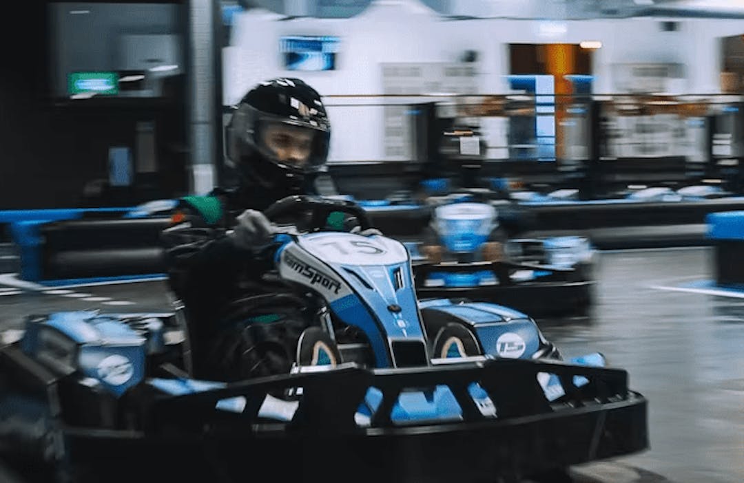 Three karters racing in blue electric karts