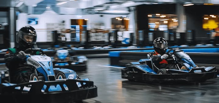 Three karters racing in blue electric karts